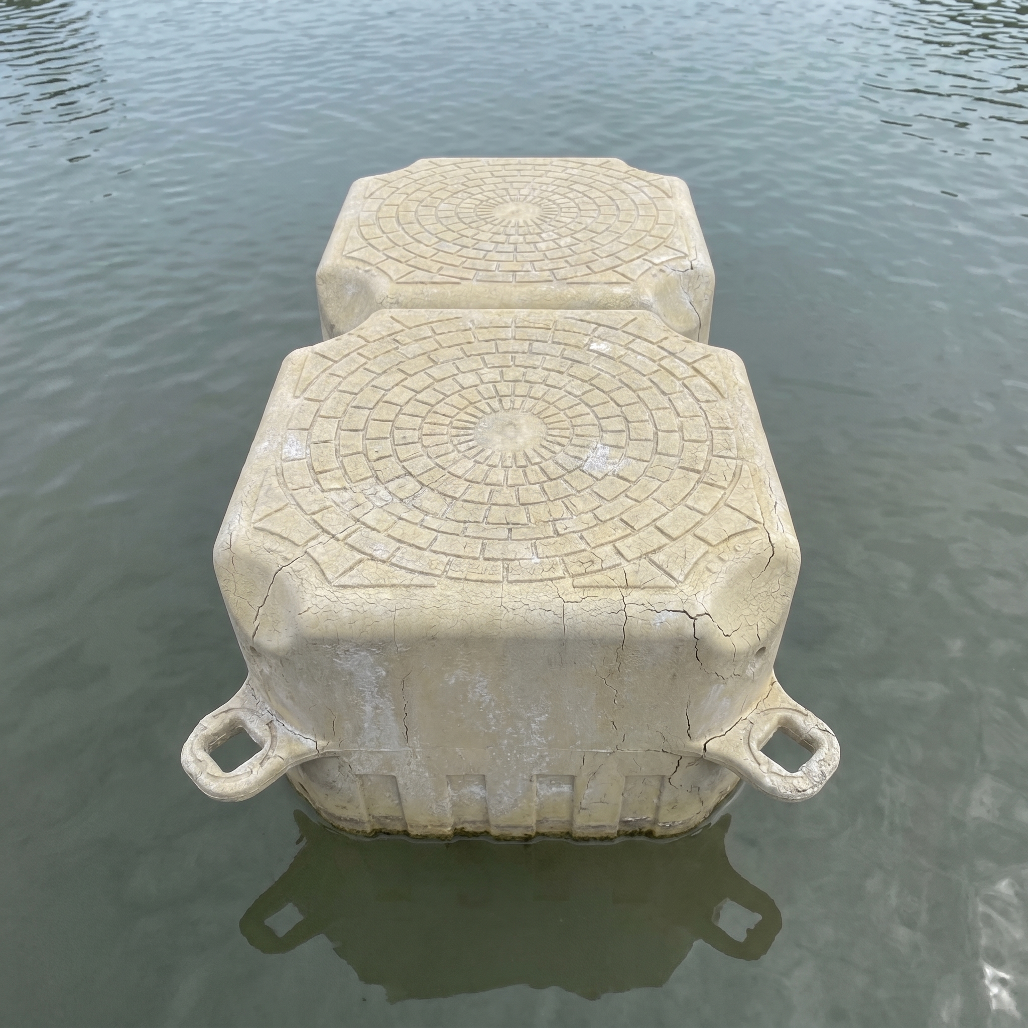 UV-degraded floating dock block showing surface crazing and hairline cracks after years in WA conditions