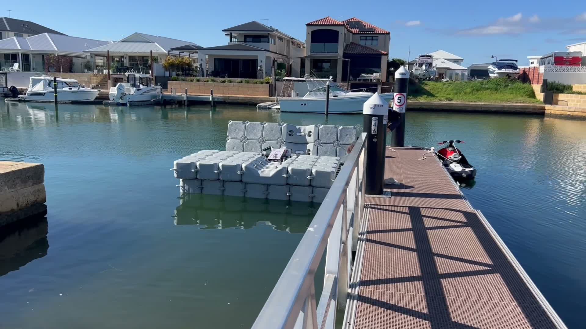 FloatX floating dock system installed at a WA canal marina, connected by aluminium gangway
