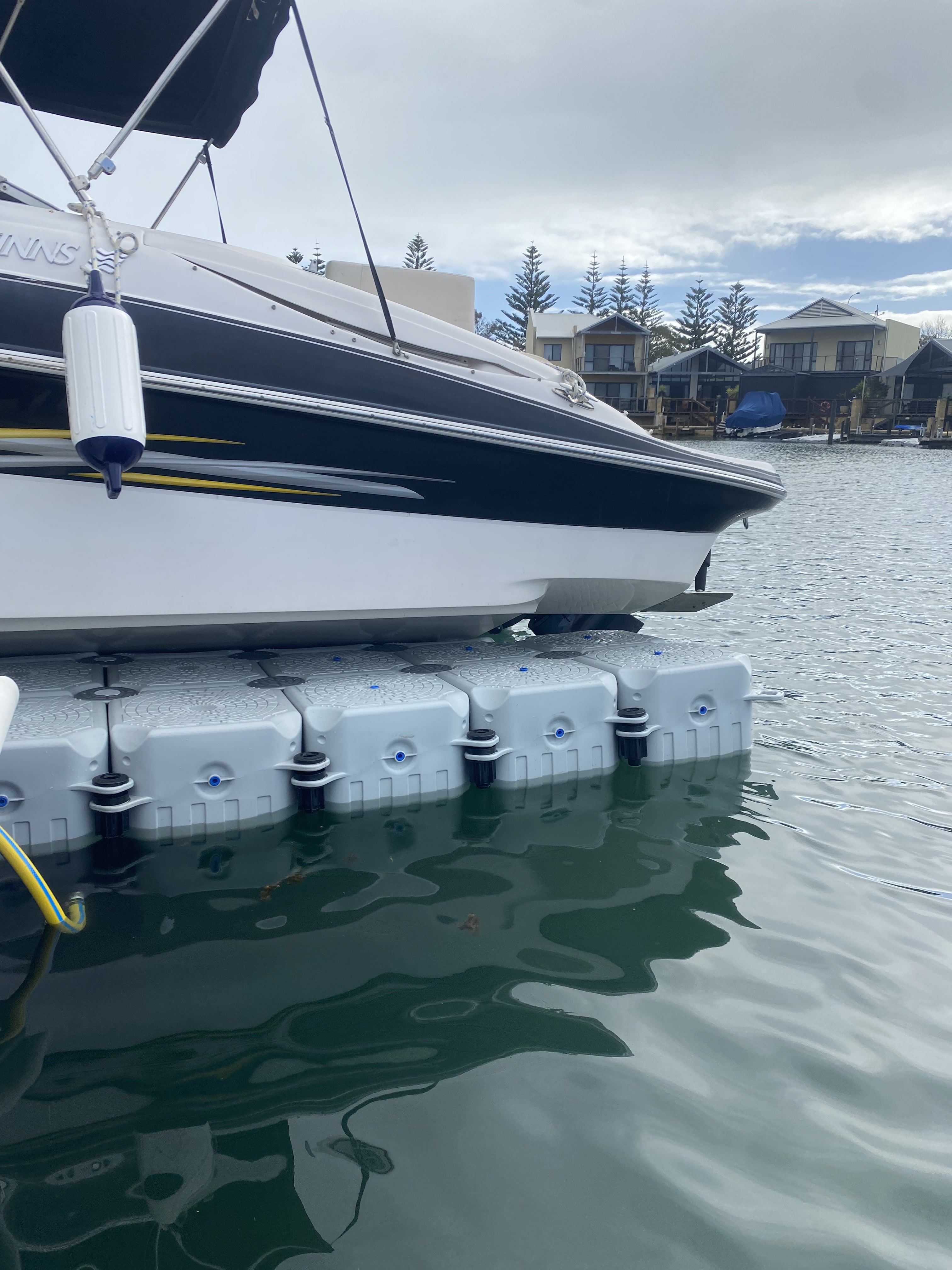 FloatX modular dock system supporting a boat hull at a WA canal estate